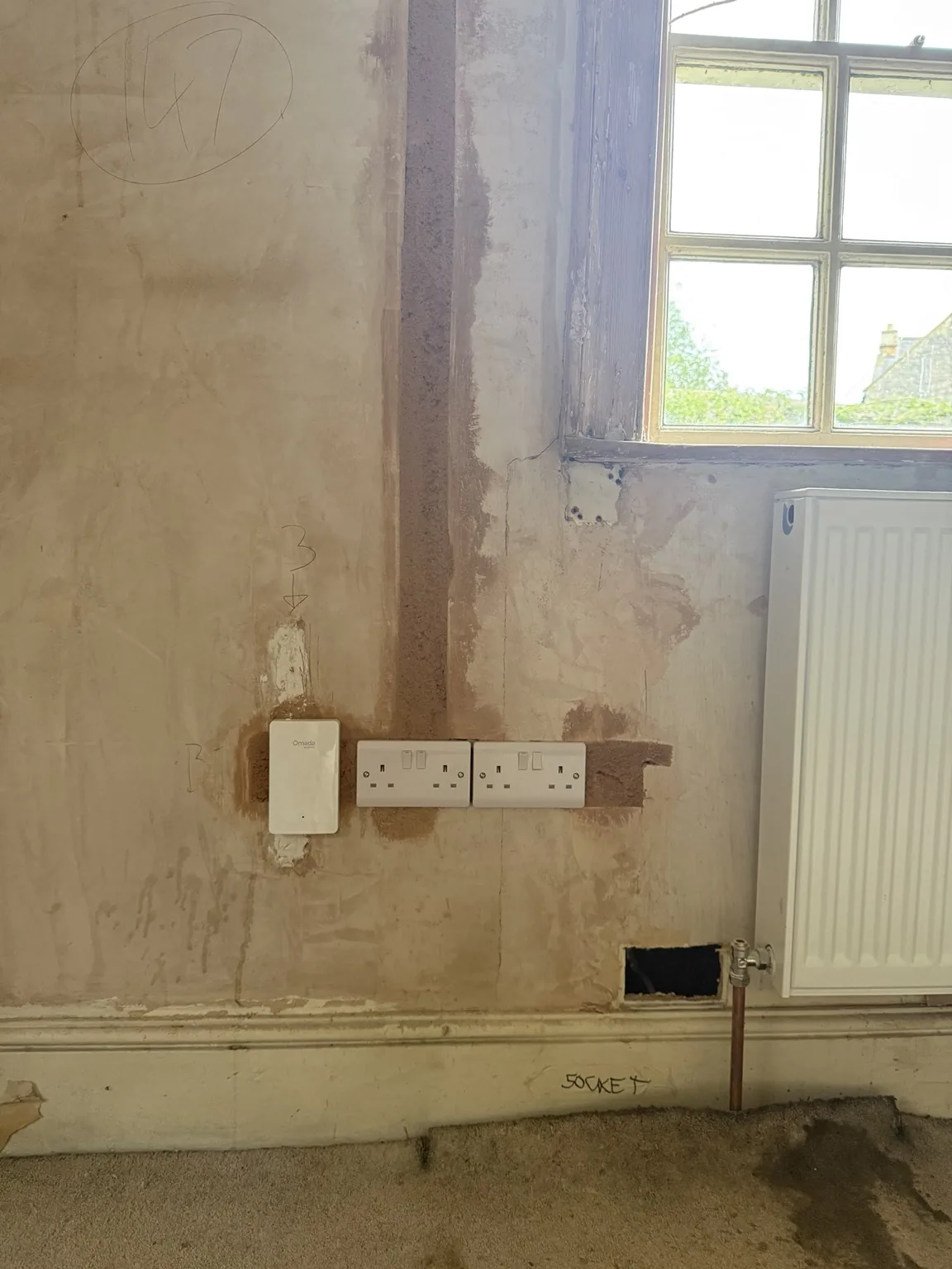 Omada Wi-Fi access point installed alongside sockets in the listed Bath property